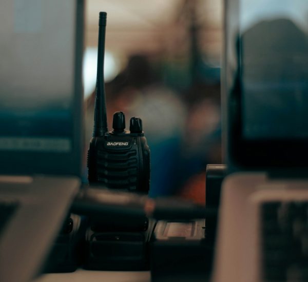 two laptops and a cell phone on a desk emergency radios responders communication gear