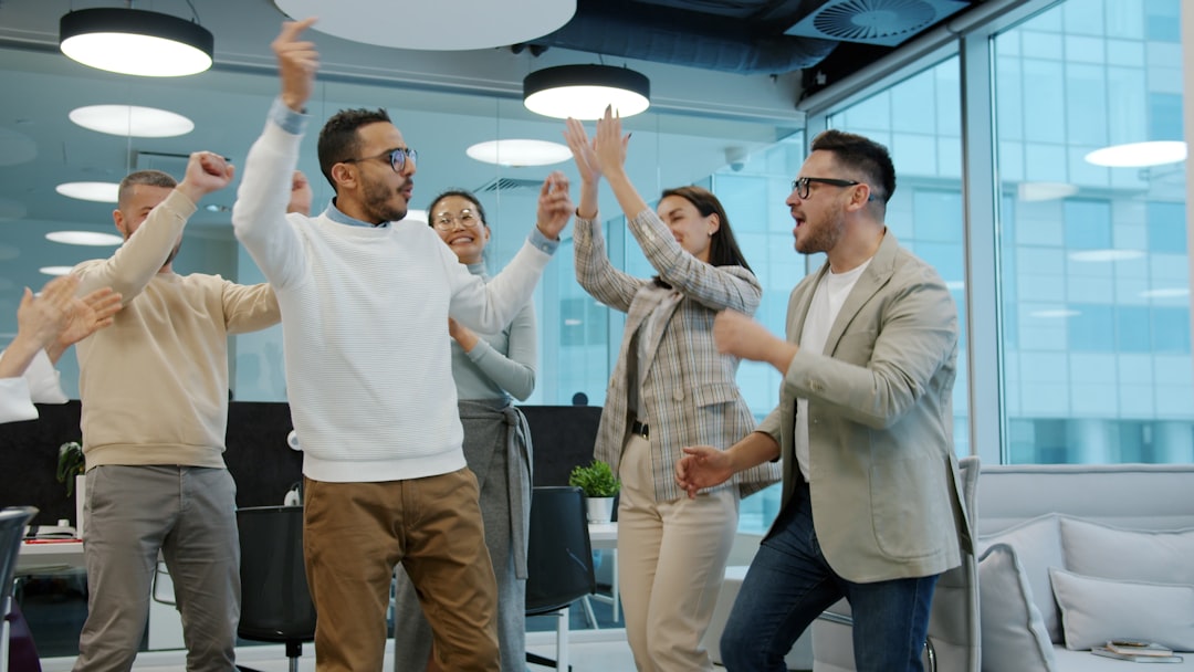 a diverse group of colleagues celebrating success in an office sales contest team energy office fun trophies 2