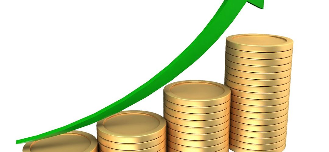 stacks of coins with an upward trending green arrow financial planning interest earnings bank comparison savings goals