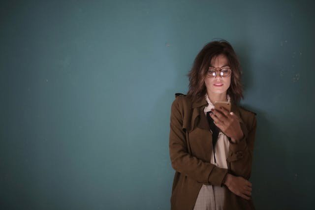 The average user will likely read your content from their mobile phone. Woman reading an article on her phone.