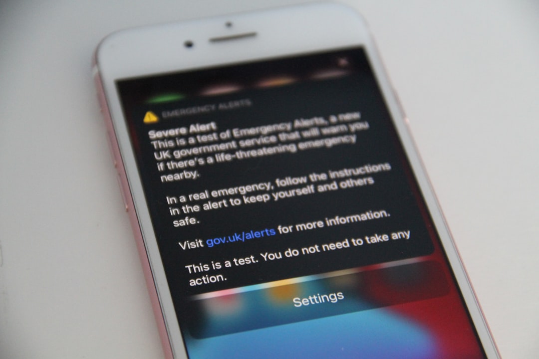 a close up of a cell phone on a table phone scam warning sign fake message
