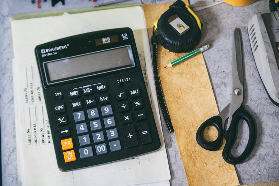 calculator and office supplies on a desk calculator fuel savings grocery rewards