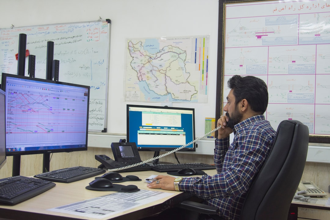 a man sitting at a desk talking on a phone project dashboard task management remote workflow