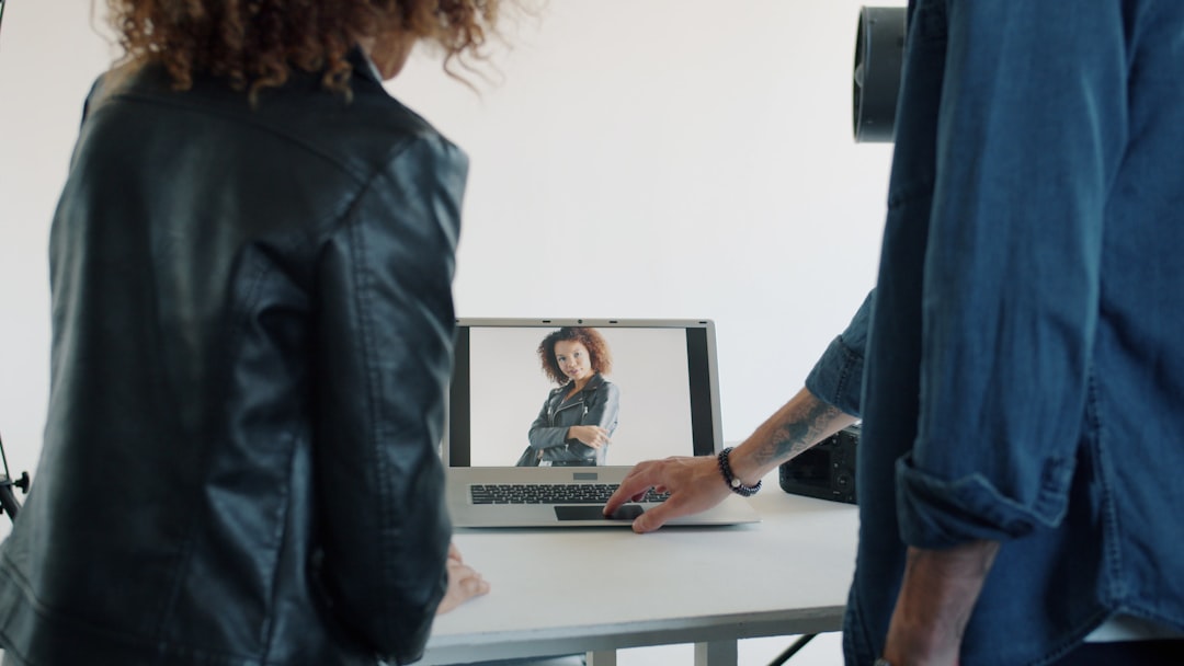 two people looking at a laptop screen asynchronous communication screen recording remote training