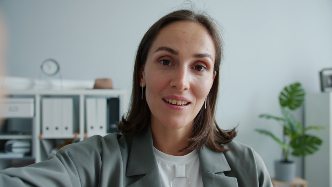 woman in a suit looking at the camera remote team video meeting collaboration tools