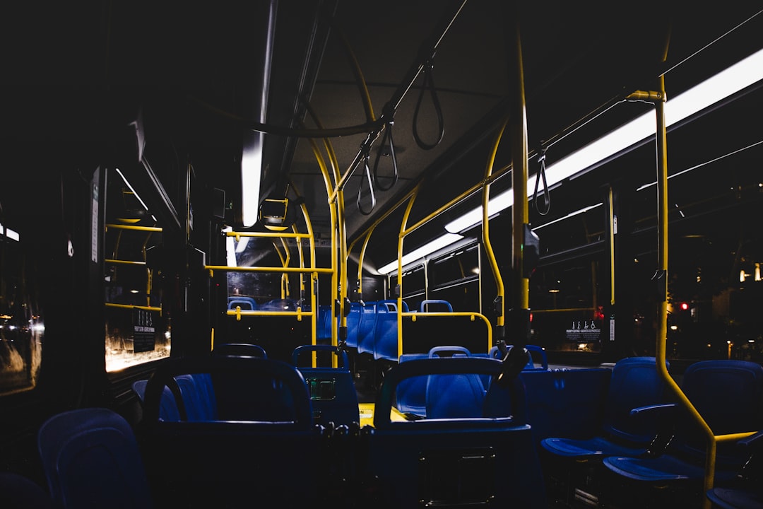 blue and black bus seats bus interior passengers safety signs public transit