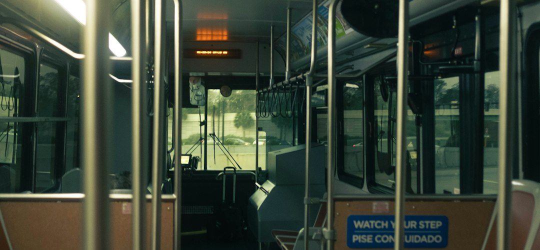 interior view of an empty public bus during the day bus interior passengers safety signs public transit