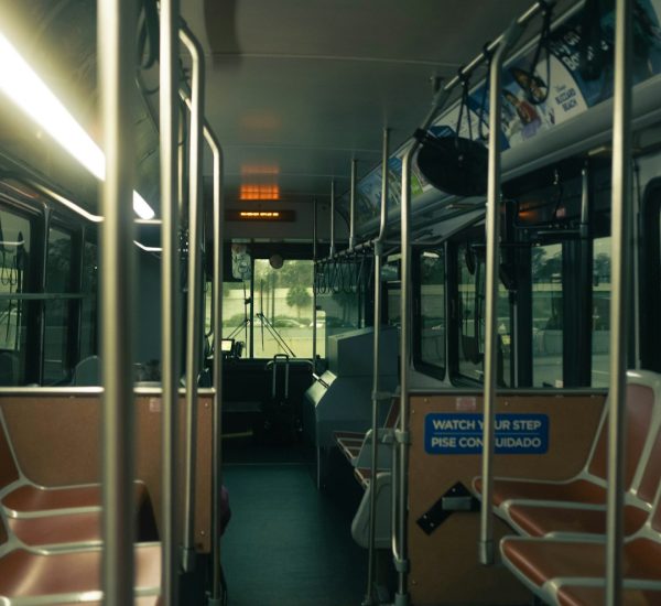 interior view of an empty public bus during the day bus interior passengers safety signs public transit