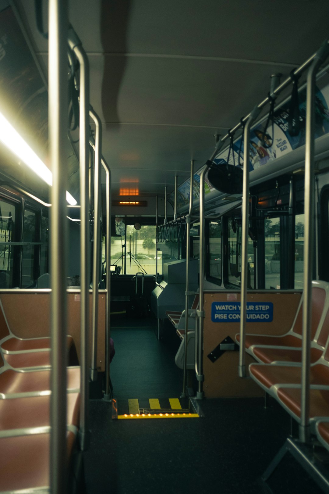 interior view of an empty public bus during the day bus interior passengers safety signs public transit