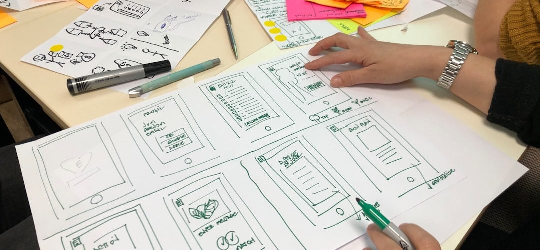 person writing on printing paper mobile app workshop product strategy design system enterprise collaboration