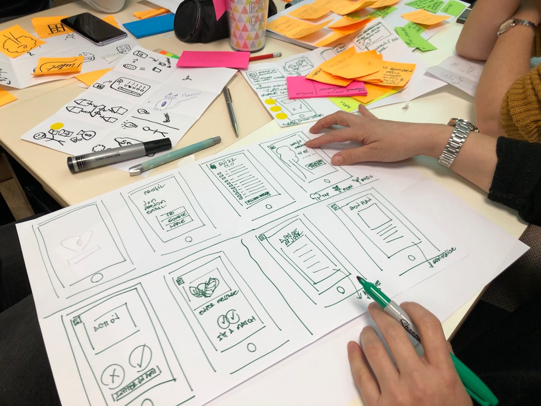 person writing on printing paper mobile app workshop product strategy design system enterprise collaboration