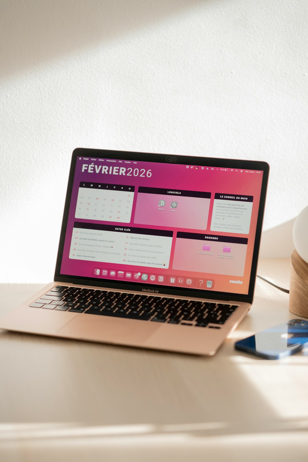 laptop displaying a colorful february 2026 calendar wordpress calendar booking dashboard