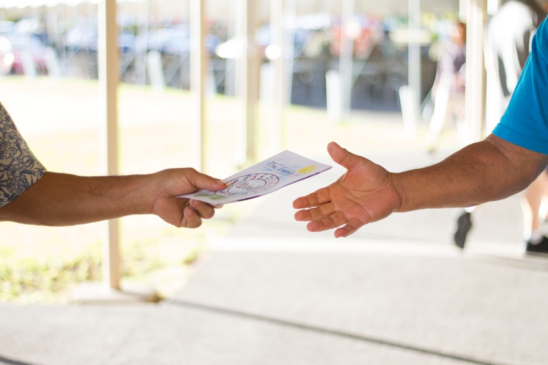 person holding card networking event hand shake business card