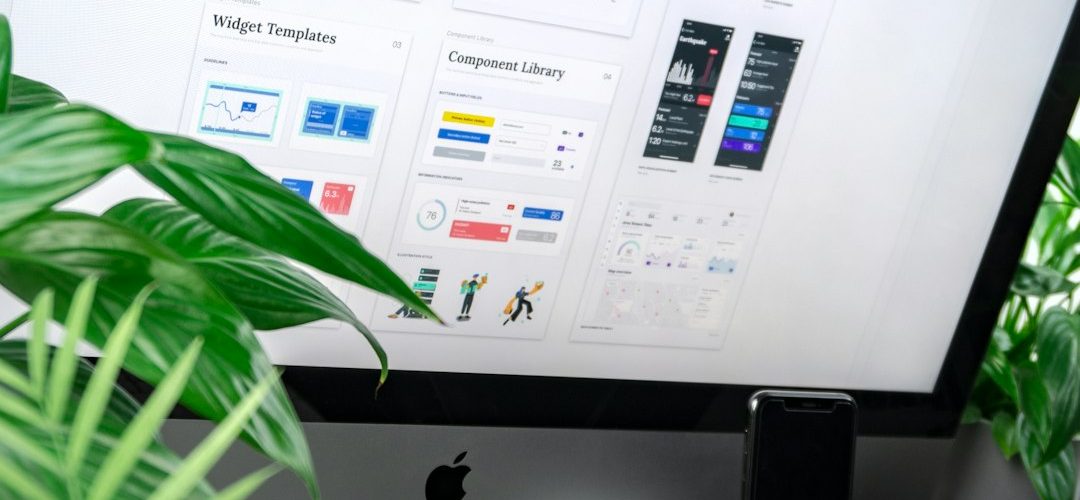 a computer monitor displaying a design system interface with plants on a desk web design team project planning client dashboard