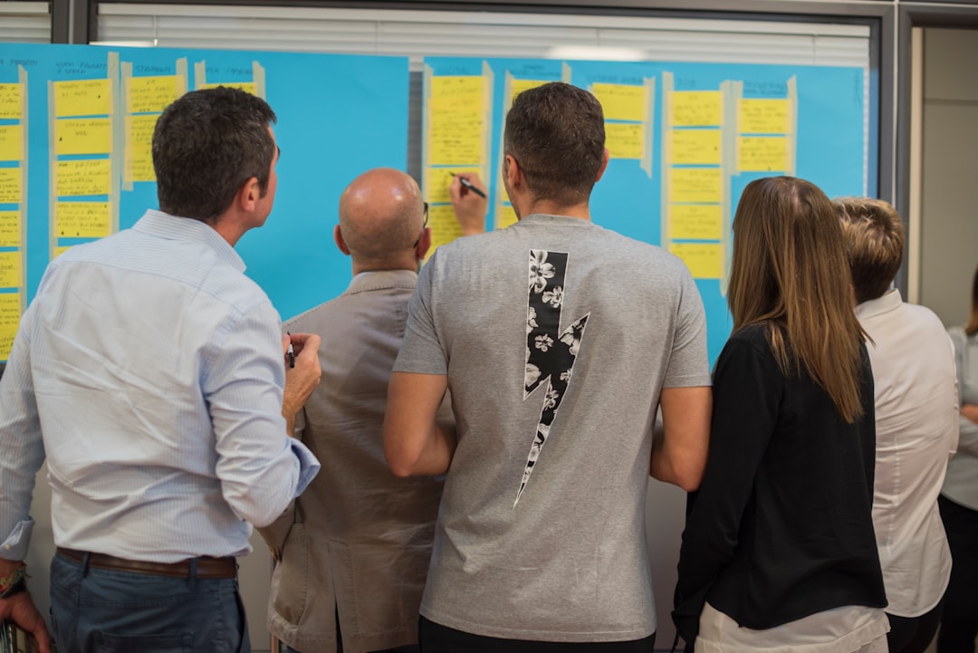 man in white dress shirt standing beside woman in black shirt sales pipeline outreach strategy team collaboration