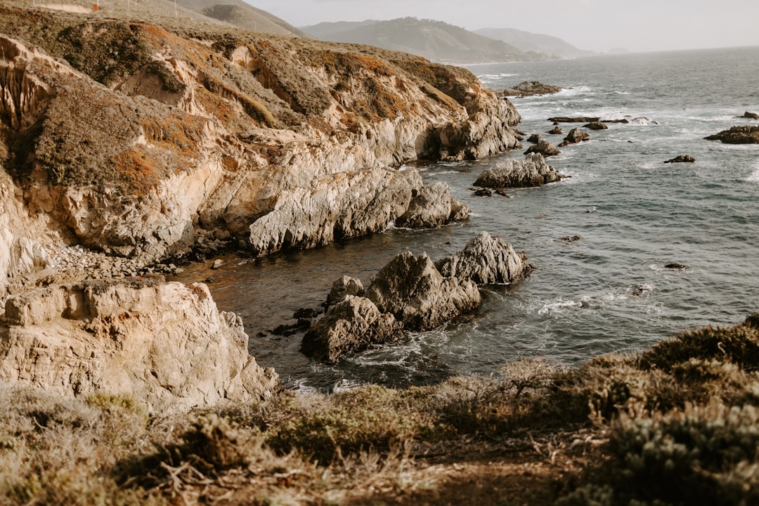 rocky coastline with waves crashing on shore carmel coast ocean cliffs evening lights
