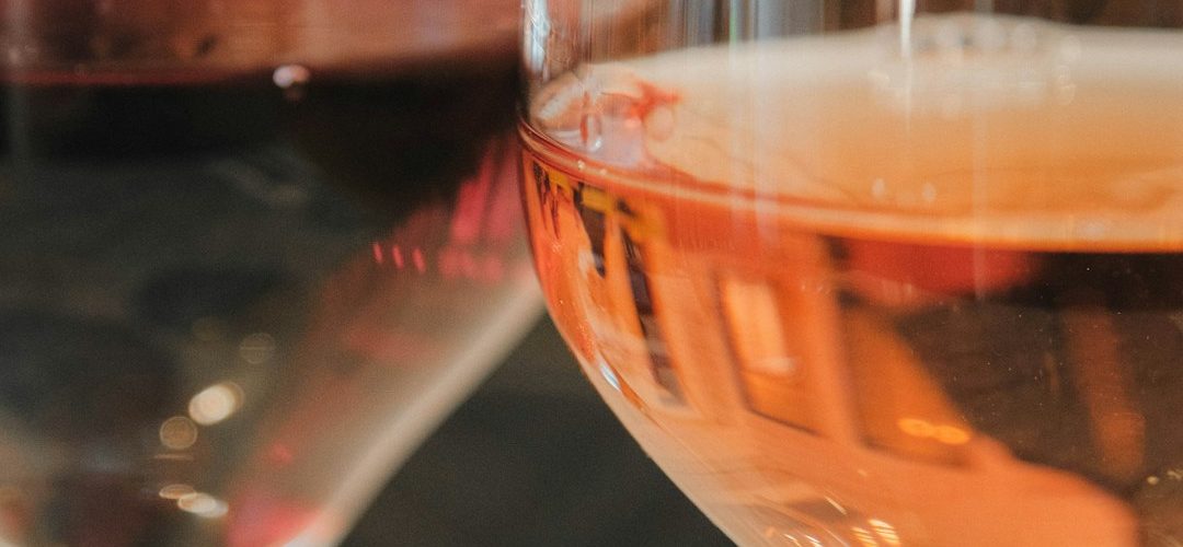 two glasses of wine one red one rose vineyard dining sunset wine glasses