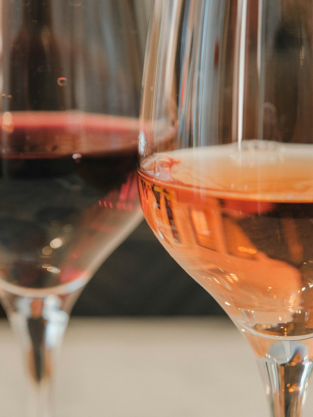 two glasses of wine one red one rose vineyard dining sunset wine glasses