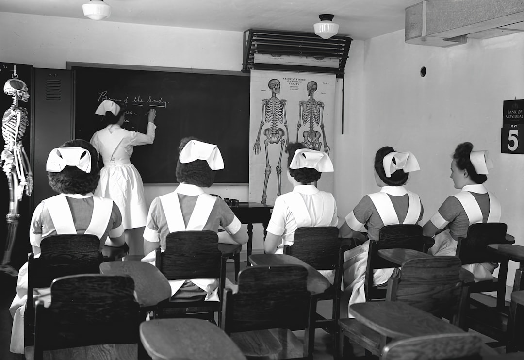 a black and white photo of a classroom virtual classroom 3d anatomy model students wearing vr headsets