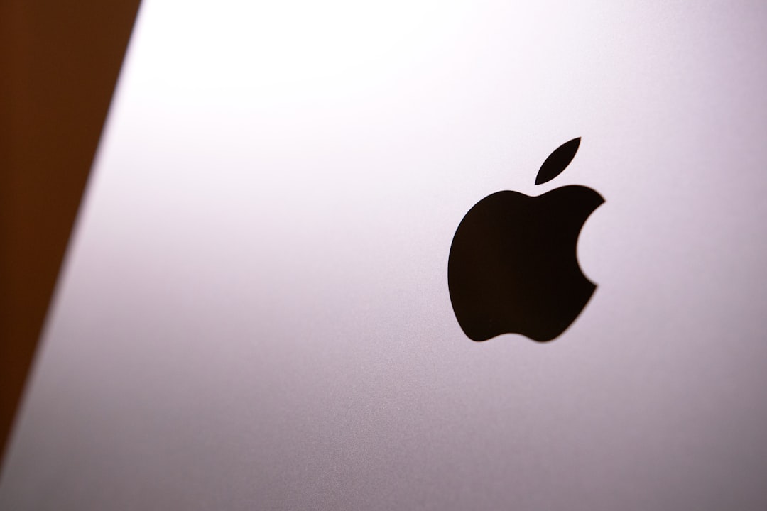 a black apple on a white surface apple silicon chip close up mac motherboard processor detail