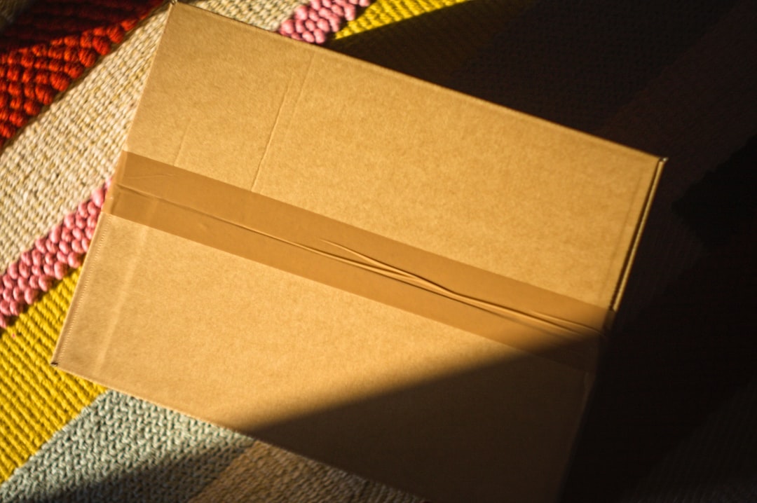 a cardboard box taped shut on a colorful rug customer service shipping box receipt
