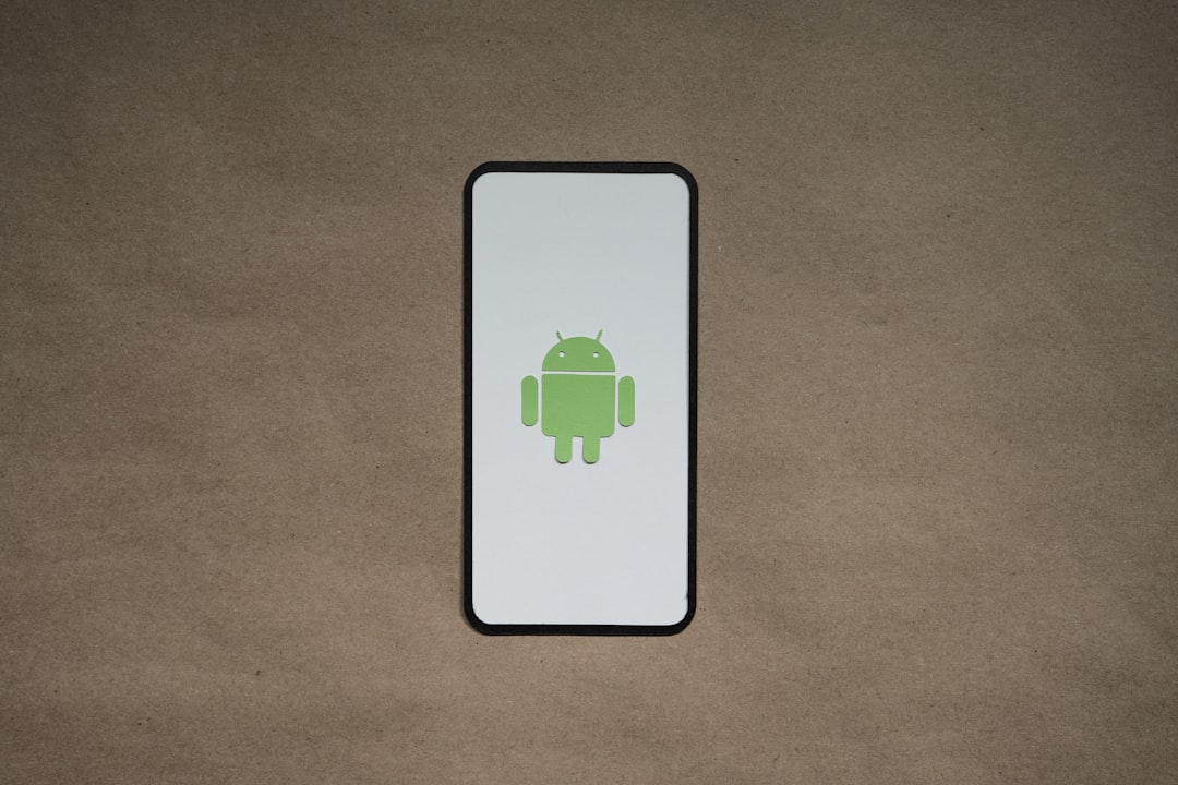a cell phone with a green icon on it android phone battery warning shutdown screen