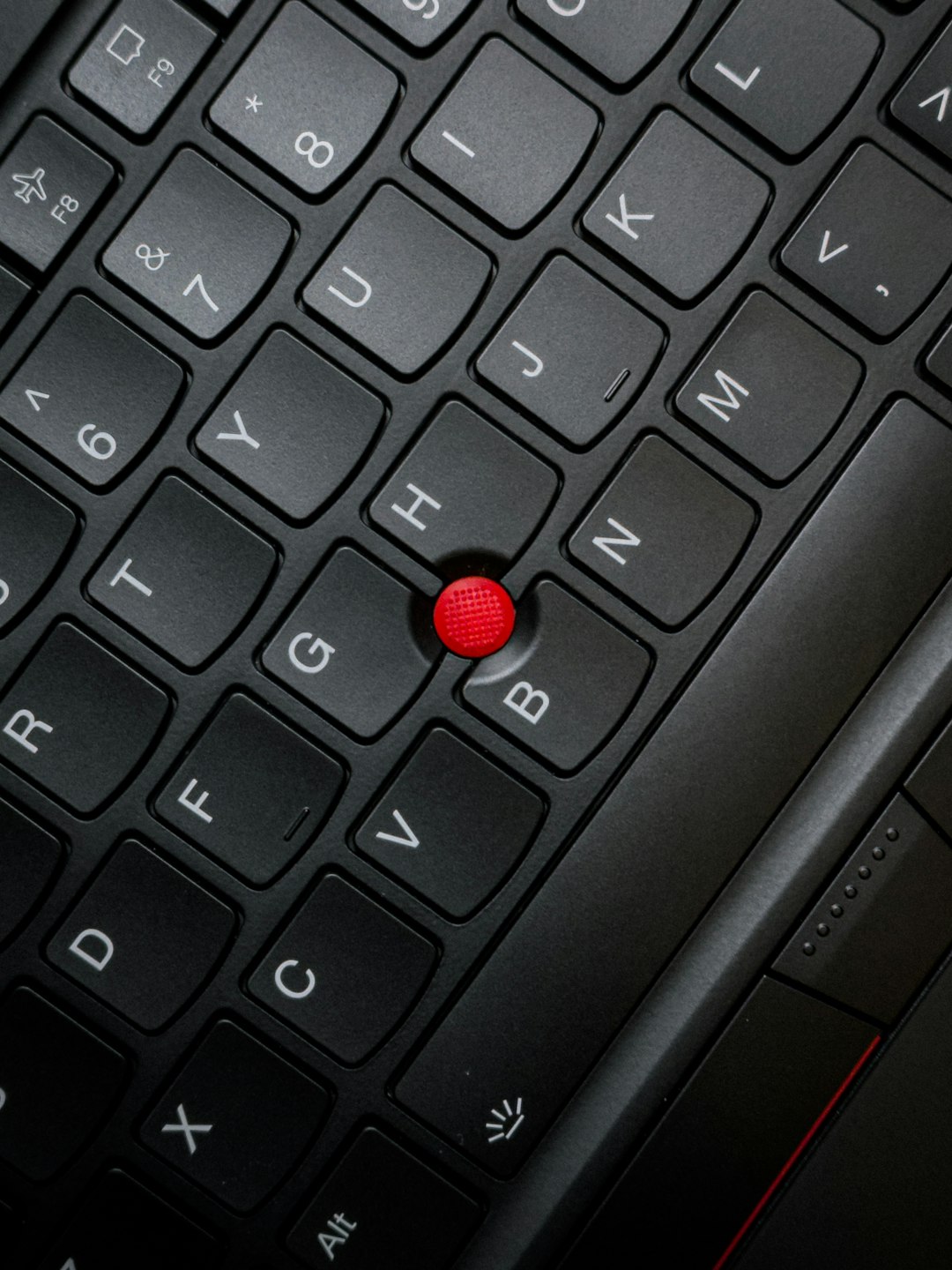 a close up of a keyboard with a red button laptop reboot bios menu keyboard keys