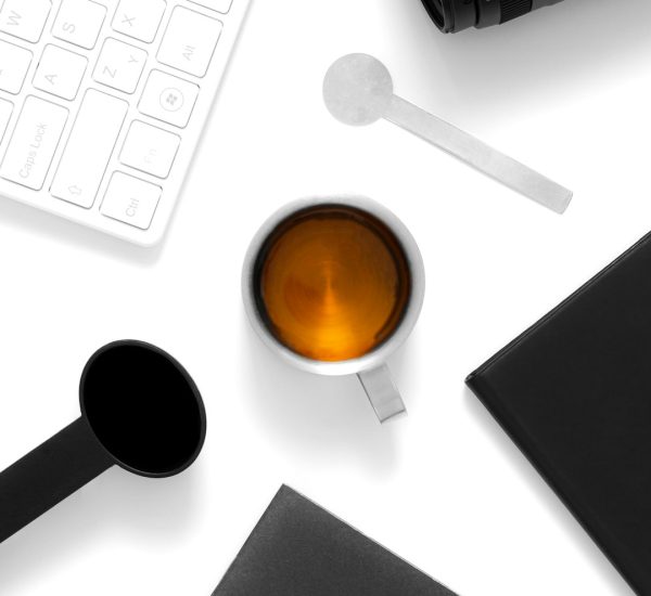 a cup of coffee and a cell phone on a table background removal product photo transparent png
