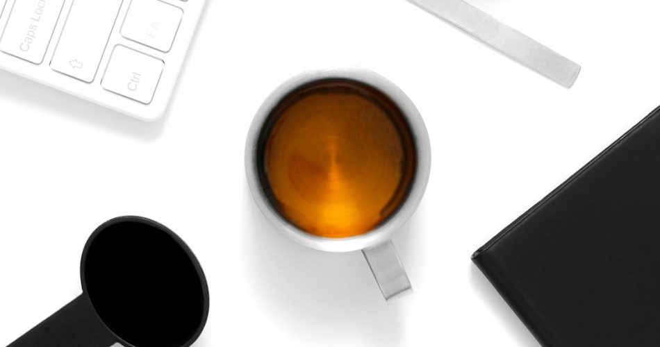 a cup of coffee and a cell phone on a table background removal product photo transparent png