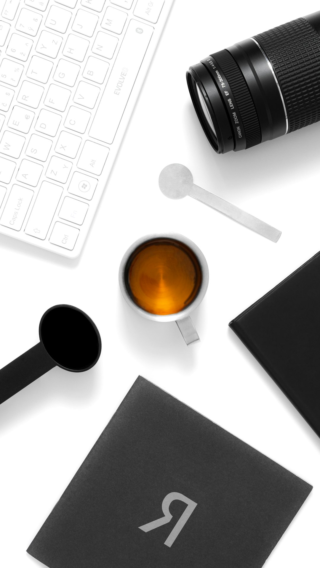 a cup of coffee and a cell phone on a table background removal product photo transparent png
