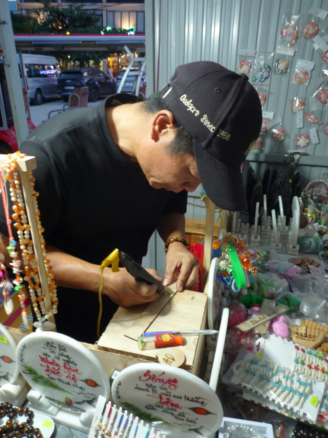 a man crafting jewelry at a market stall market stall handmade products happy customer entrepreneur