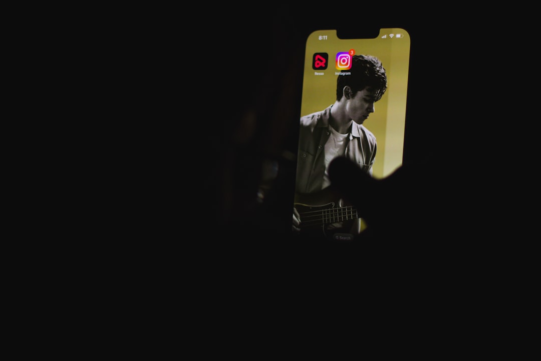 a man playing a guitar in the dark mobile creator face swap reels editing smartphone video