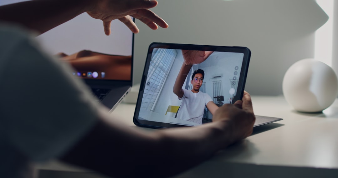 a man standing in front of a computer screen video interpreter screen patient care clinical consultation