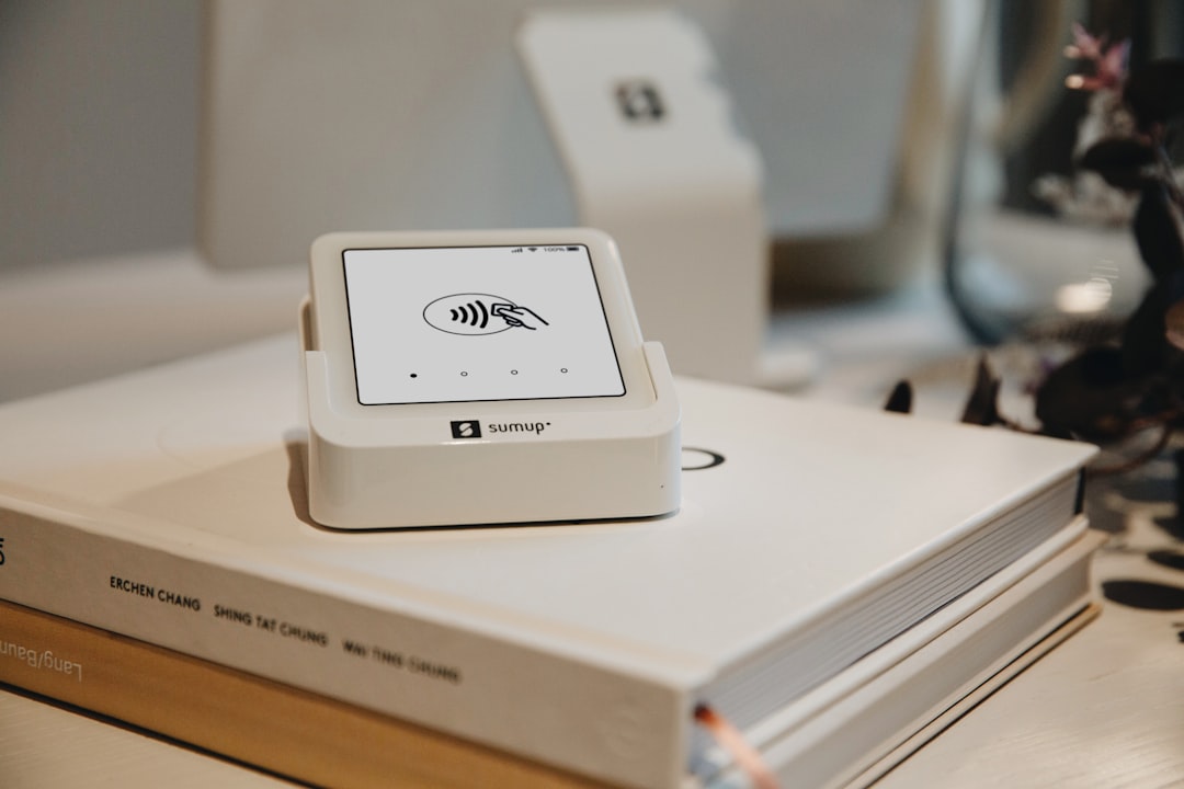 a payment terminal sits atop a book automation workflow connected apps robot assistant small business