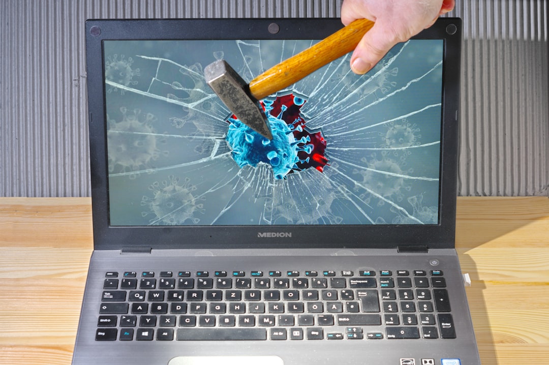 a person holding a pencil and a broken laptop safe mode repair menu windows laptop