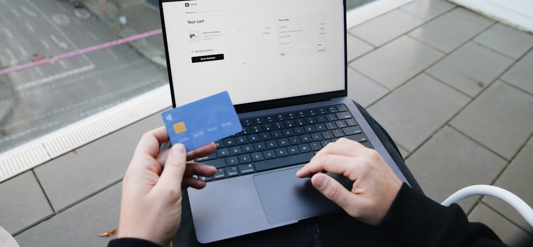 a person sitting in a chair with a laptop and a credit card online shopping size chart laptop