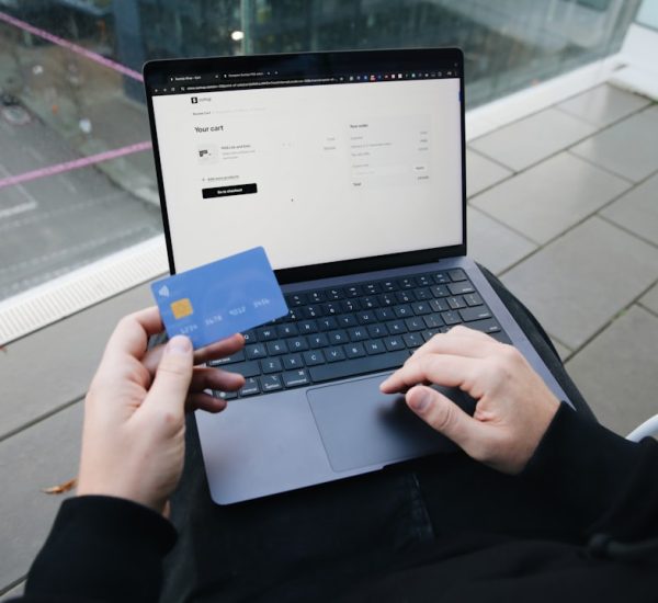 a person sitting in a chair with a laptop and a credit card online shopping size chart laptop