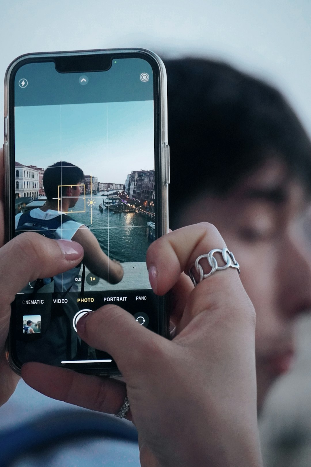 a person taking a picture with a cell phone mobile creator face swap reels editing smartphone video