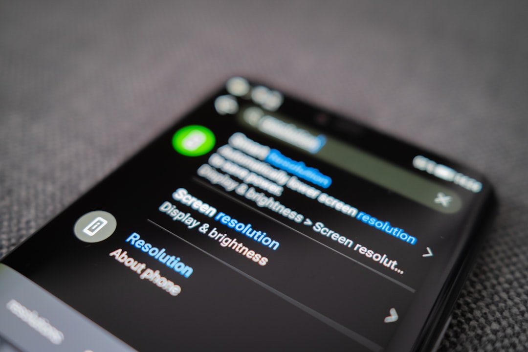 black android smartphone on gray textile android phone battery warning shutdown screen