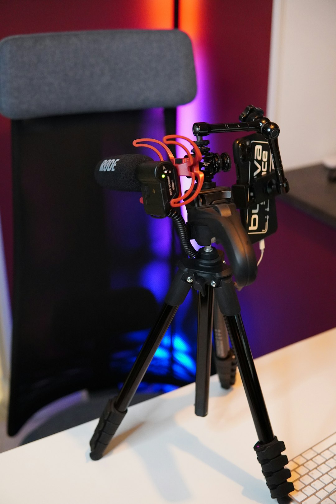 black camera with tripod on black table tripod camera microphone video gear desk setup