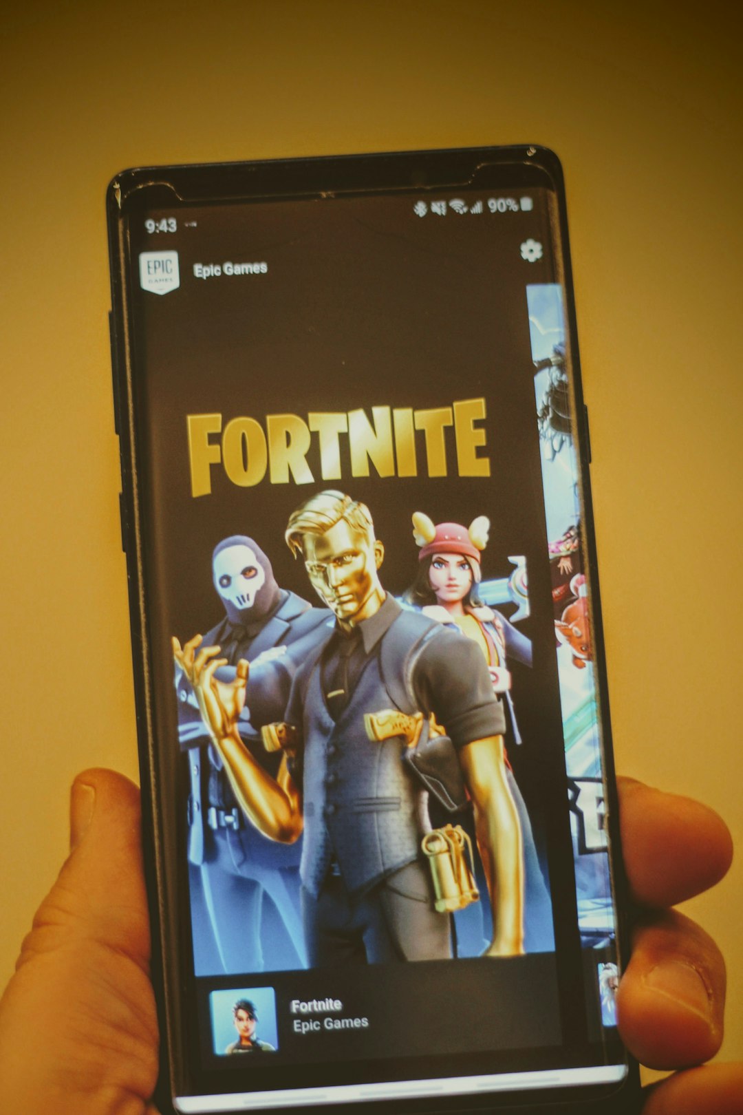black samsung android smartphone displaying man in blue suit fortnite lobby friends list crossplay invite