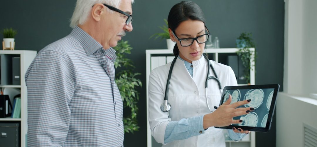 doctor shows medical scan to elderly patient doctor interpreter tablet patient communication hospital