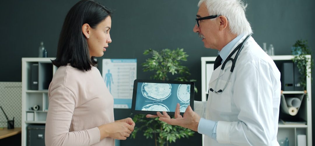 doctor shows patient medical scan on tablet doctor interpreter tablet patient communication hospital