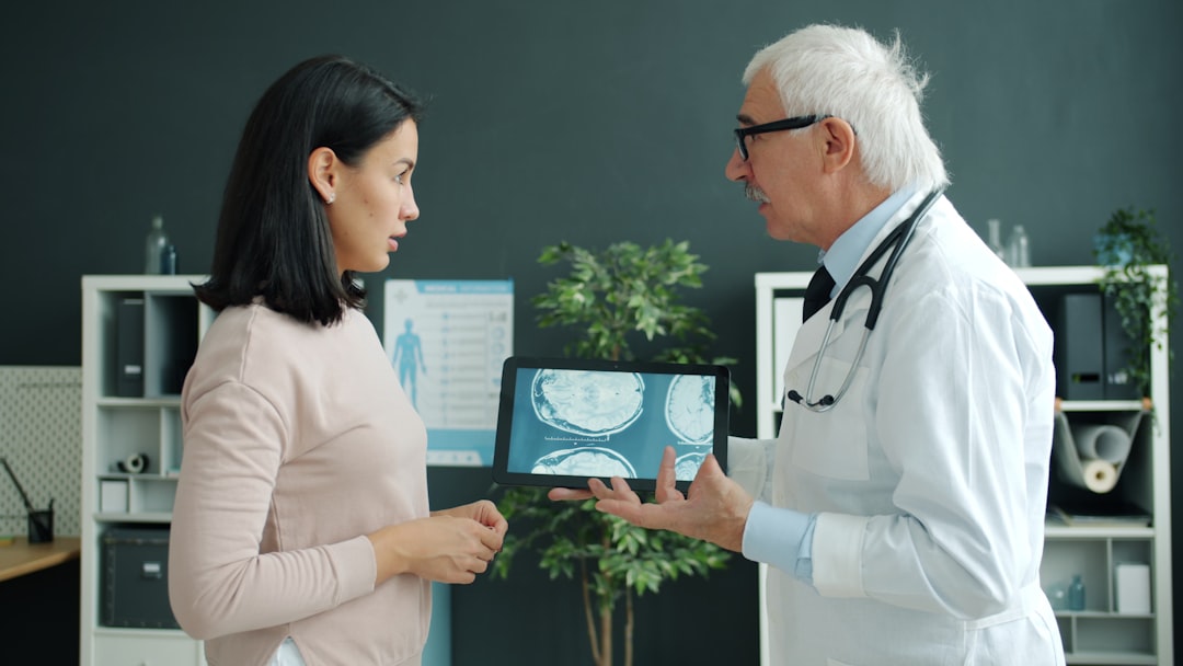 doctor shows patient medical scan on tablet doctor interpreter tablet patient communication hospital