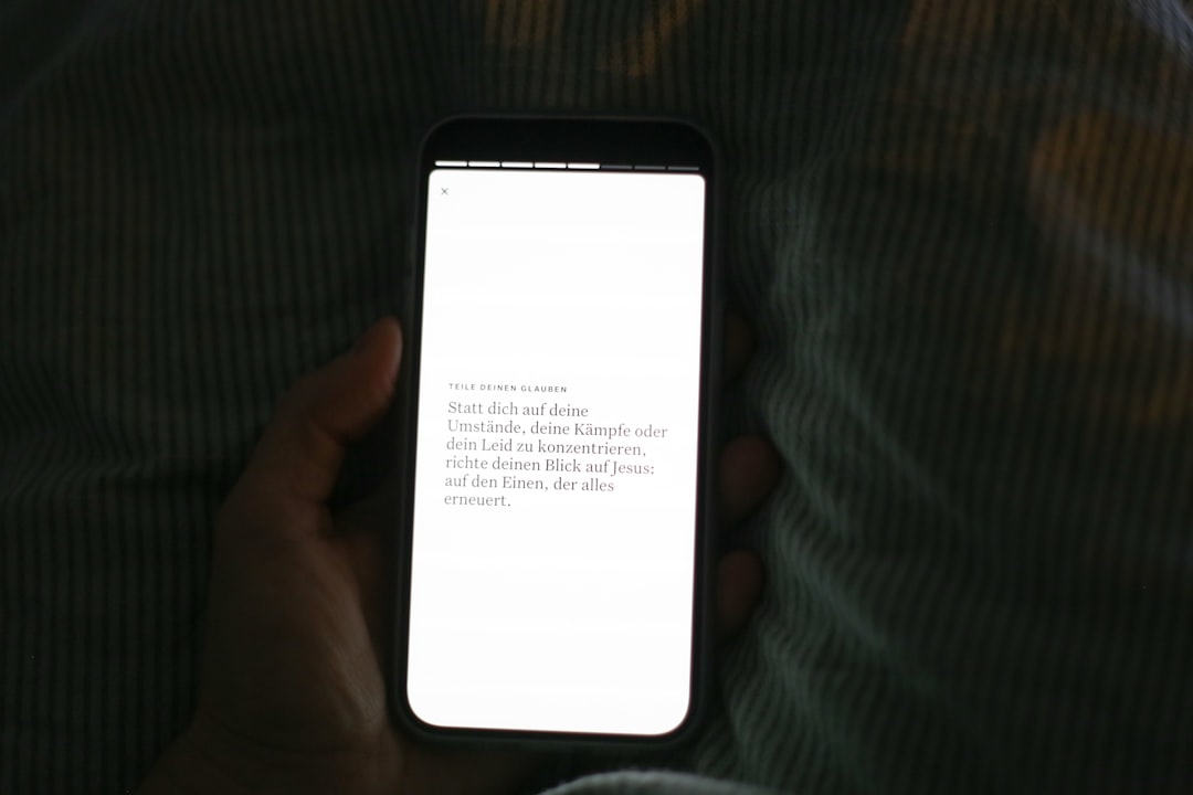 hand holding smartphone with bright white screen iphone reset network settings screen ios settings menu