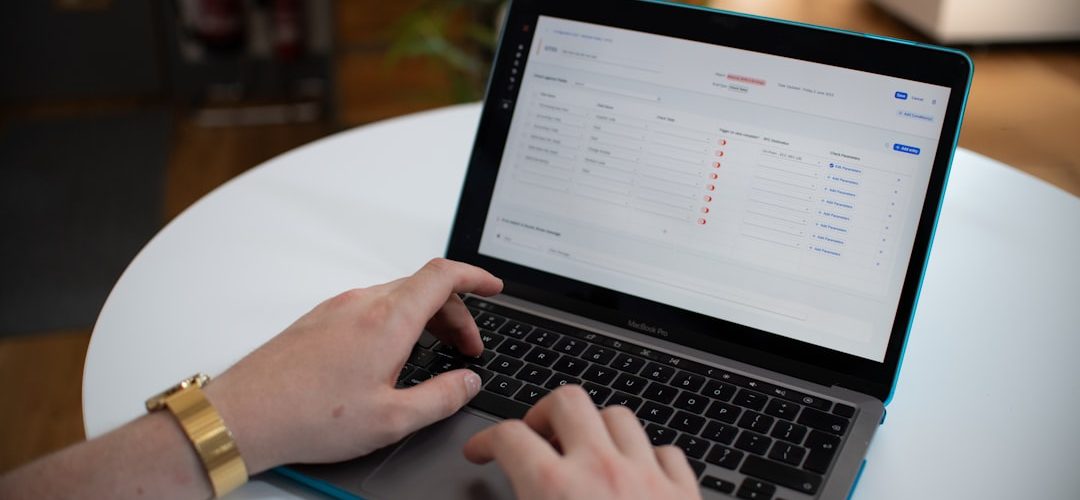 hands typing on a laptop with a spreadsheet on screen workflow automation business systems ai dashboard 3