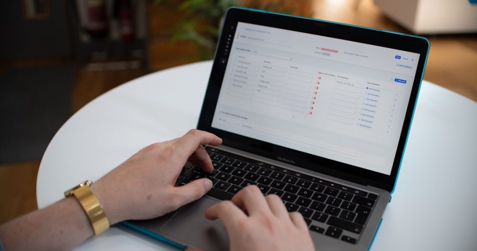 hands typing on a laptop with a spreadsheet on screen workflow automation business systems ai dashboard 5