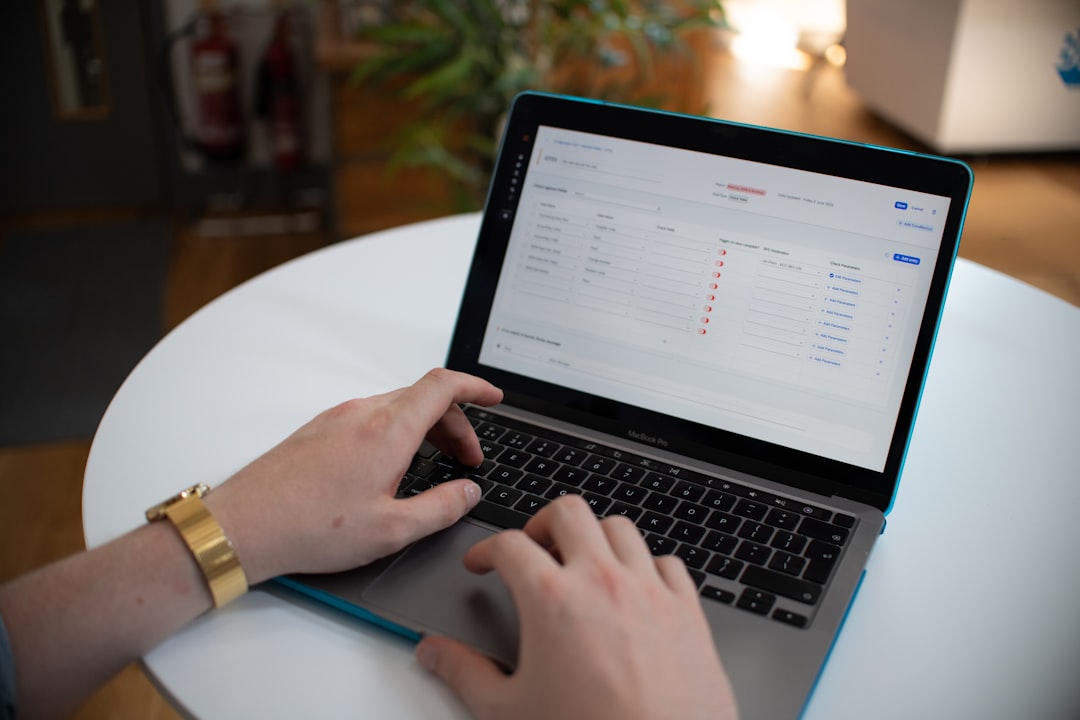 hands typing on a laptop with a spreadsheet on screen workflow automation business systems ai dashboard