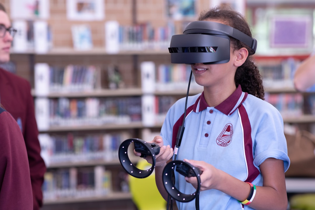 man in white and red polo shirt wearing black headphones virtual classroom 3d anatomy model students wearing vr headsets