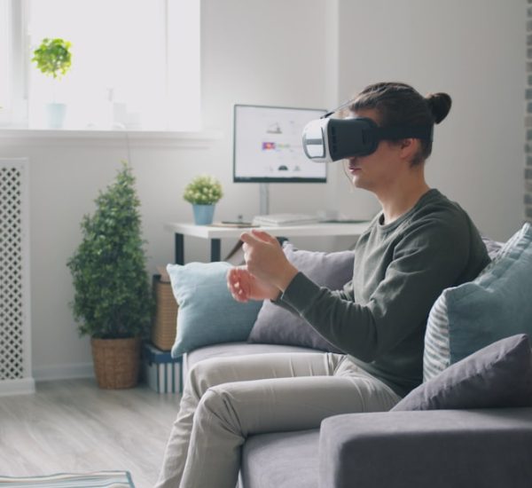 man wearing vr headset playing video game on couch virtual reality headset user immersive digital environment 3d avatar interaction